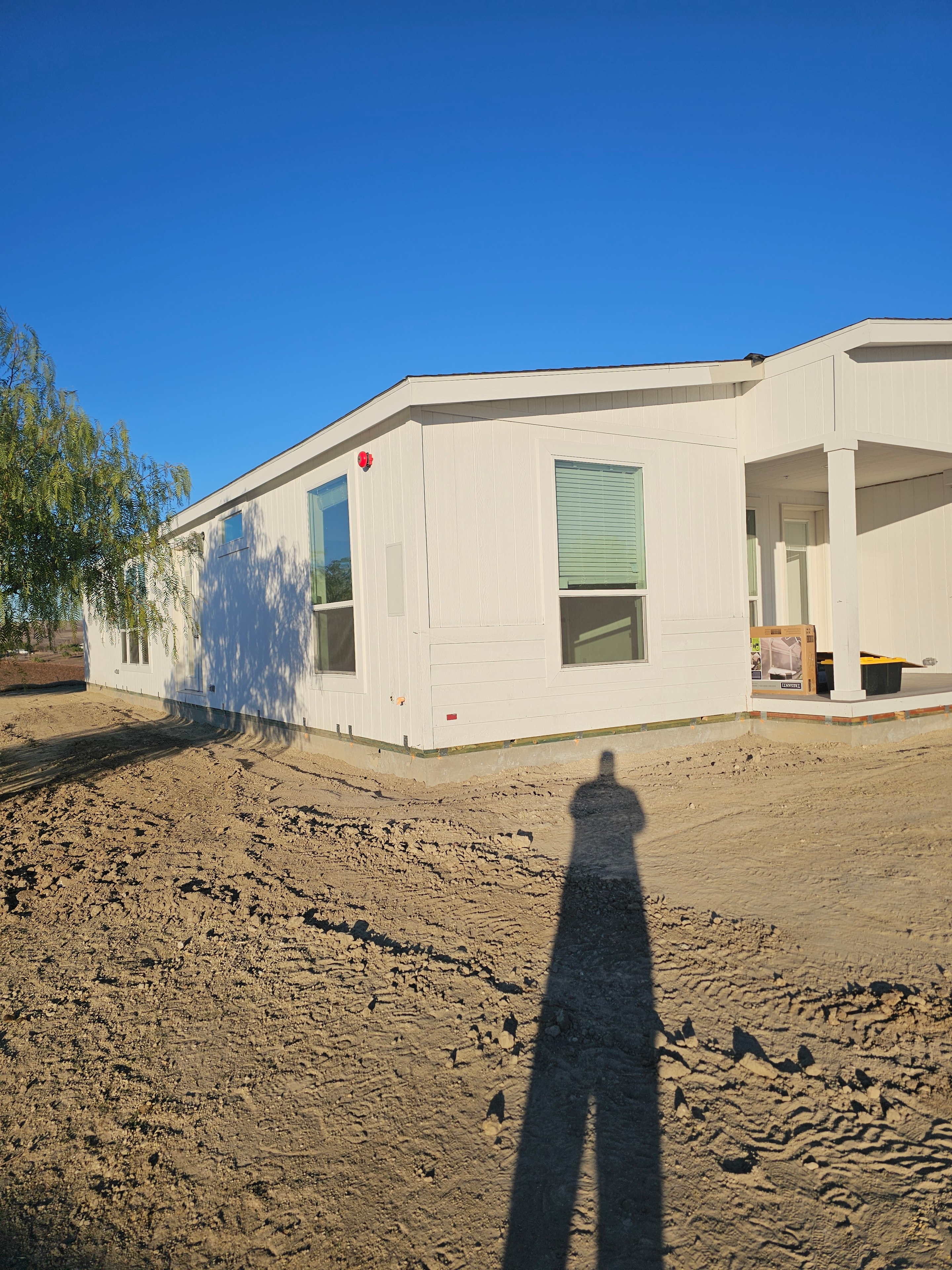 Completed manufactured home installation with landscaping