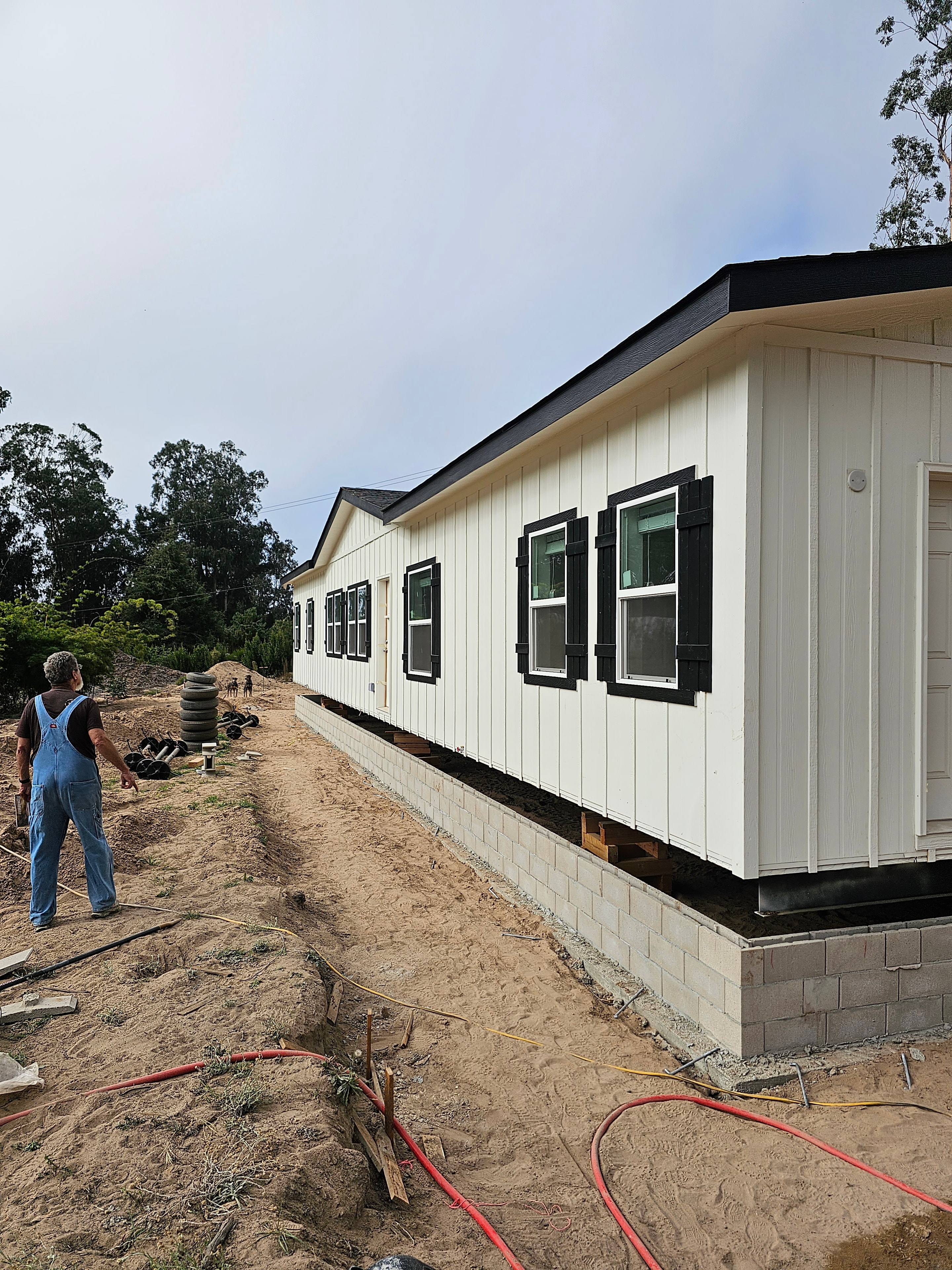 Mobile home being set onto foundation